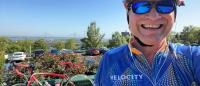 man wearing cycling helmet smiling at camera